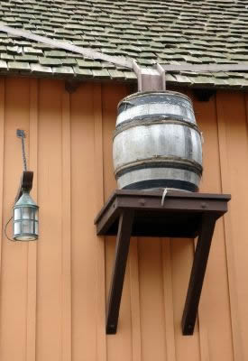 Rain barrel on side of building